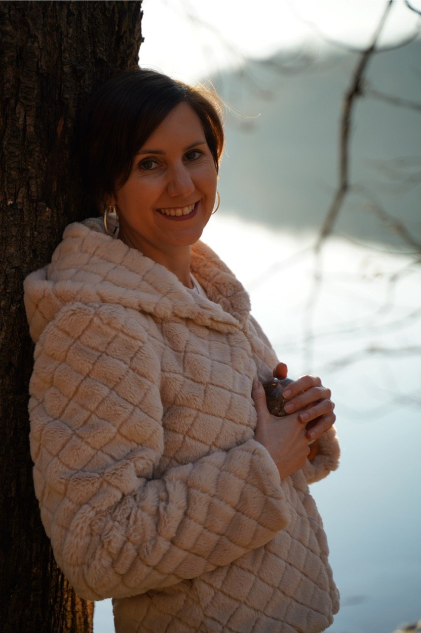 Cristina Holding Purple Stone Leaning Against Tree 1 Large